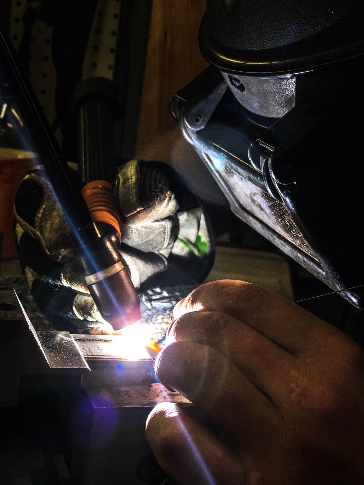 Keenan Vella TIG welding under the arc in the Vella Welding shop
