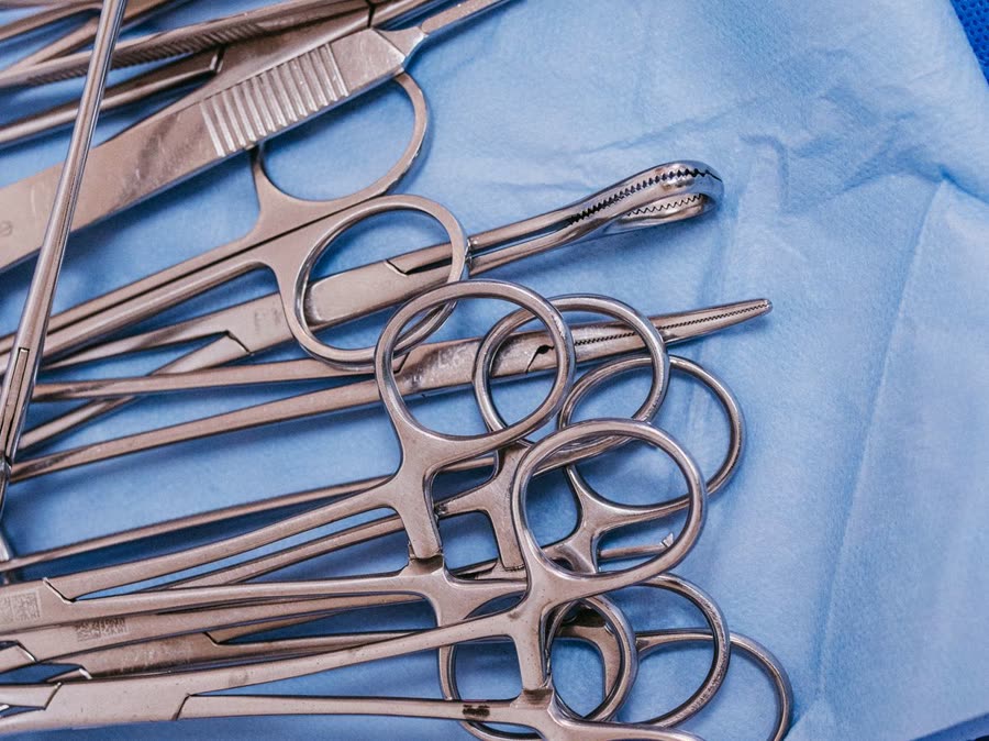 Stainless steel surgical instruments on a sterile drape