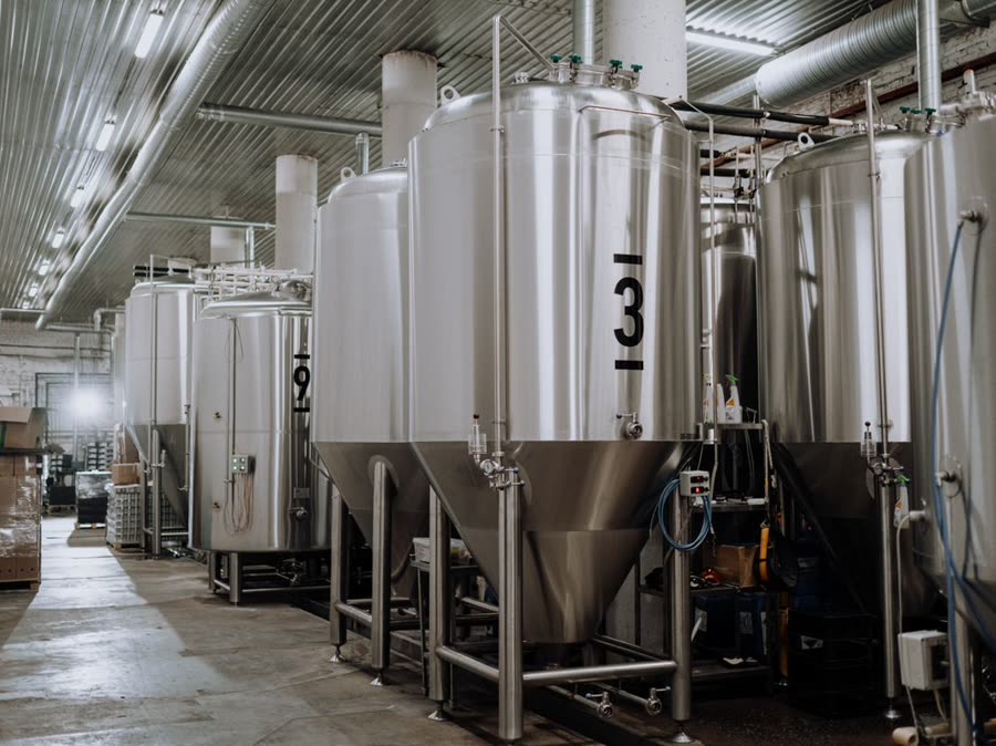 Stainless steel process tanks on a production floor