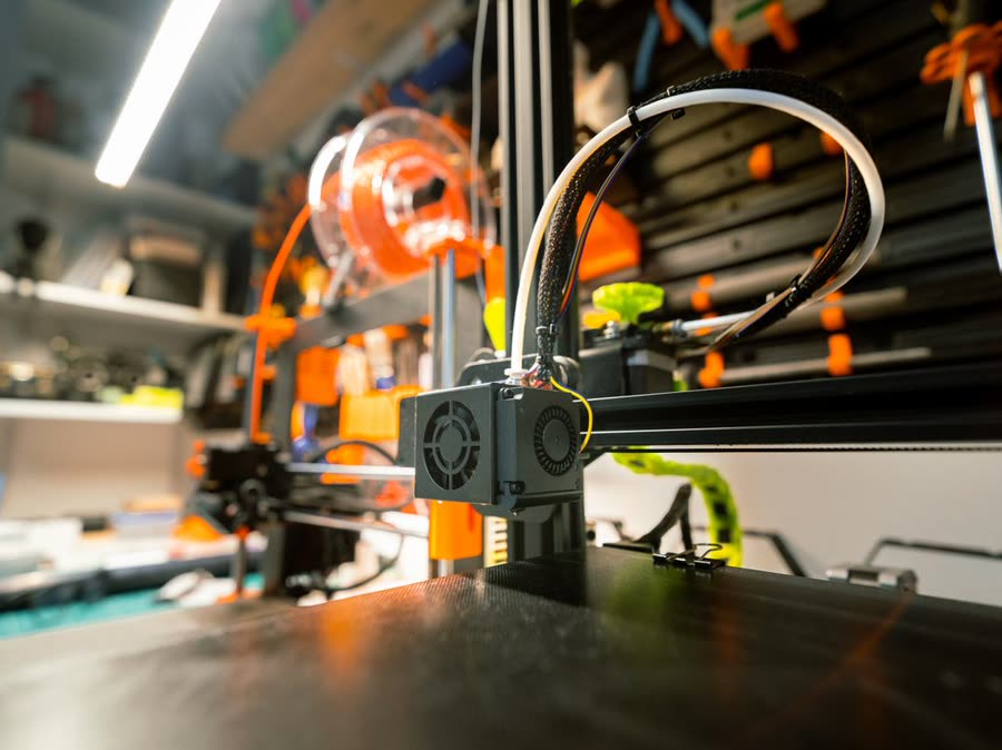3D printer building a prototype part in a workshop