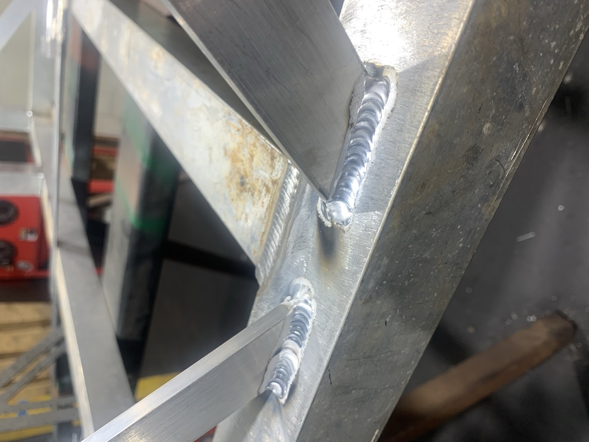 TIG welds joining gussets to an aluminum frame