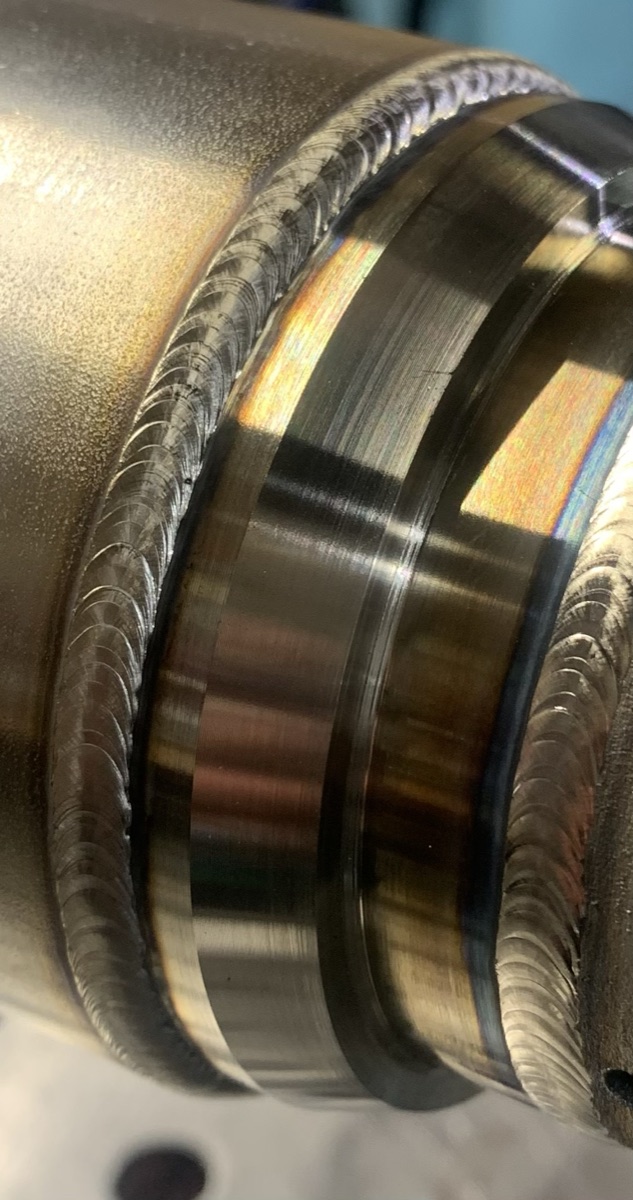 Close-up of welds on a multistage stainless pipe assembly
